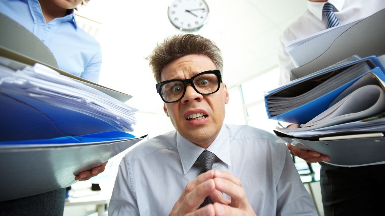 man surrounded by documents